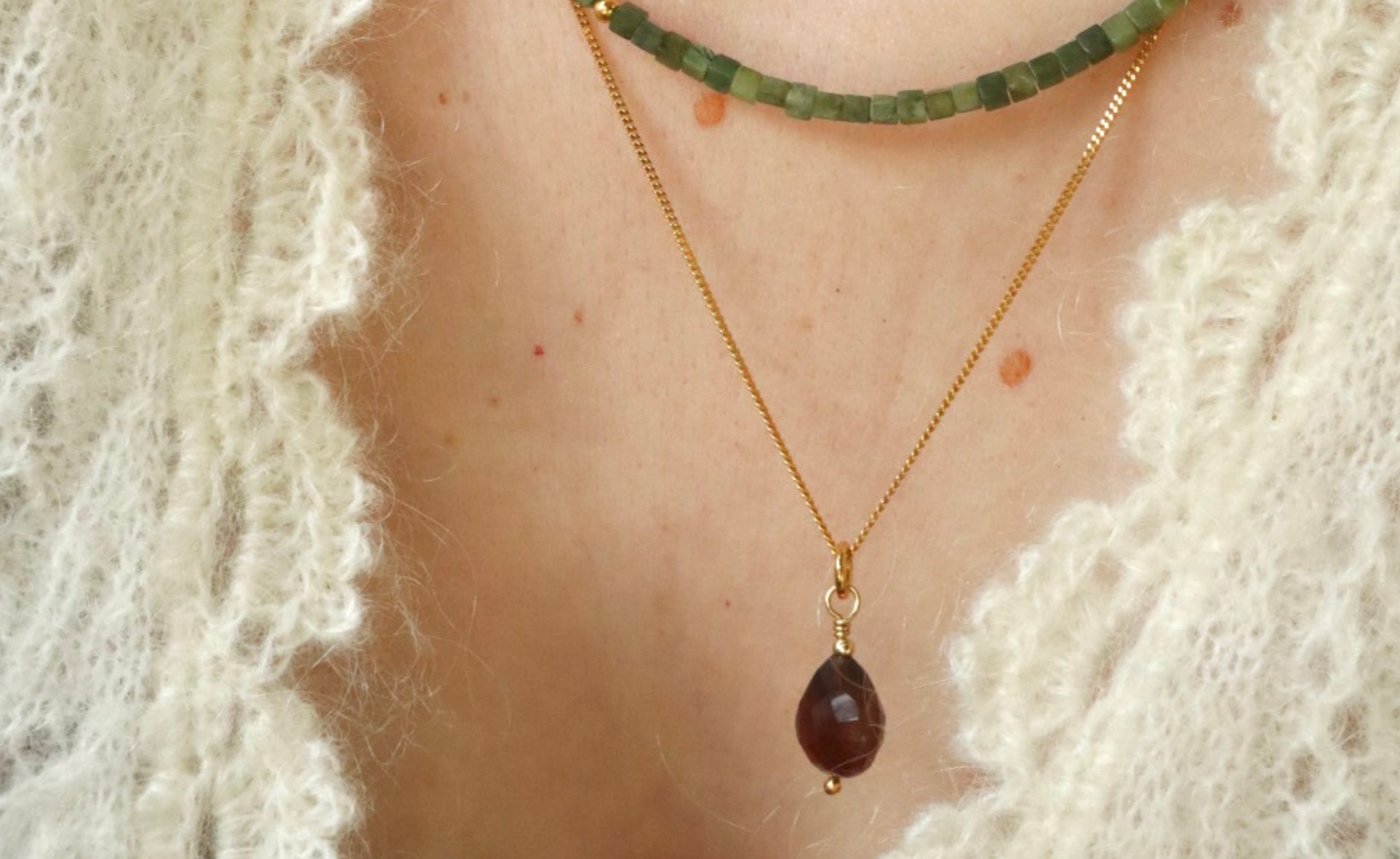 Twee edelsteen kettingen om een hals. Met groene kraaltjes en bruine chalcedoon